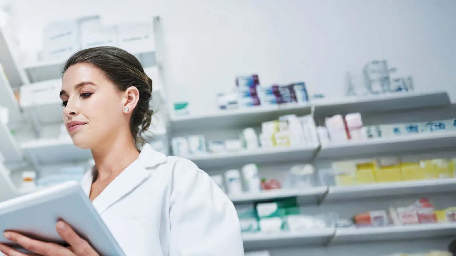 A hospital pharmacist checking stock on a tablet