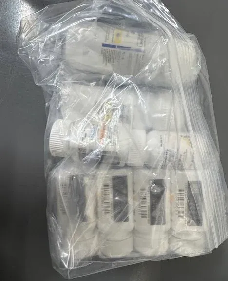 Medication bottles packed together in a sealed clear bag