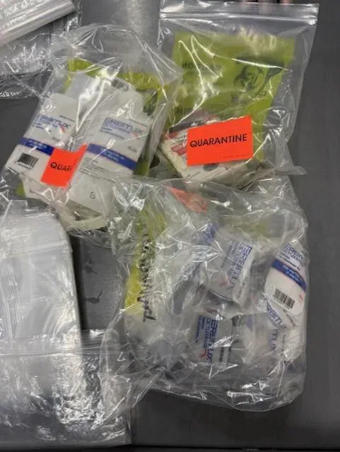 Medications sealed in bags, some marked with orange labels