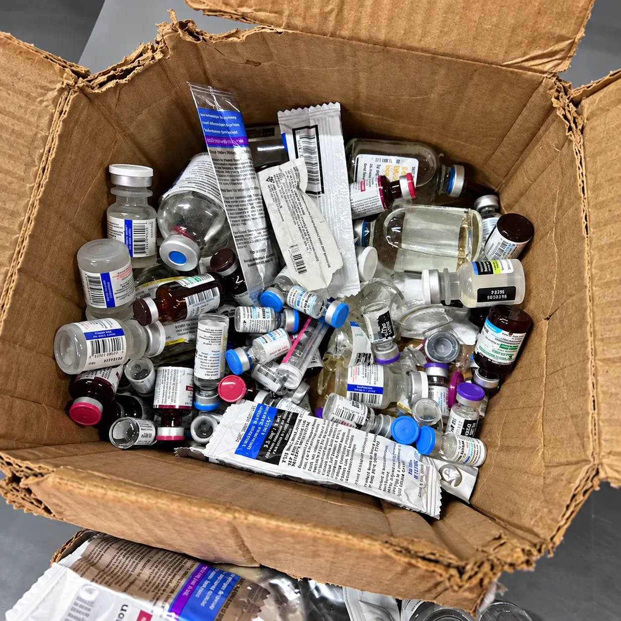 Packed wrong: a worn box overfilled with loose vials, tubes and bottles